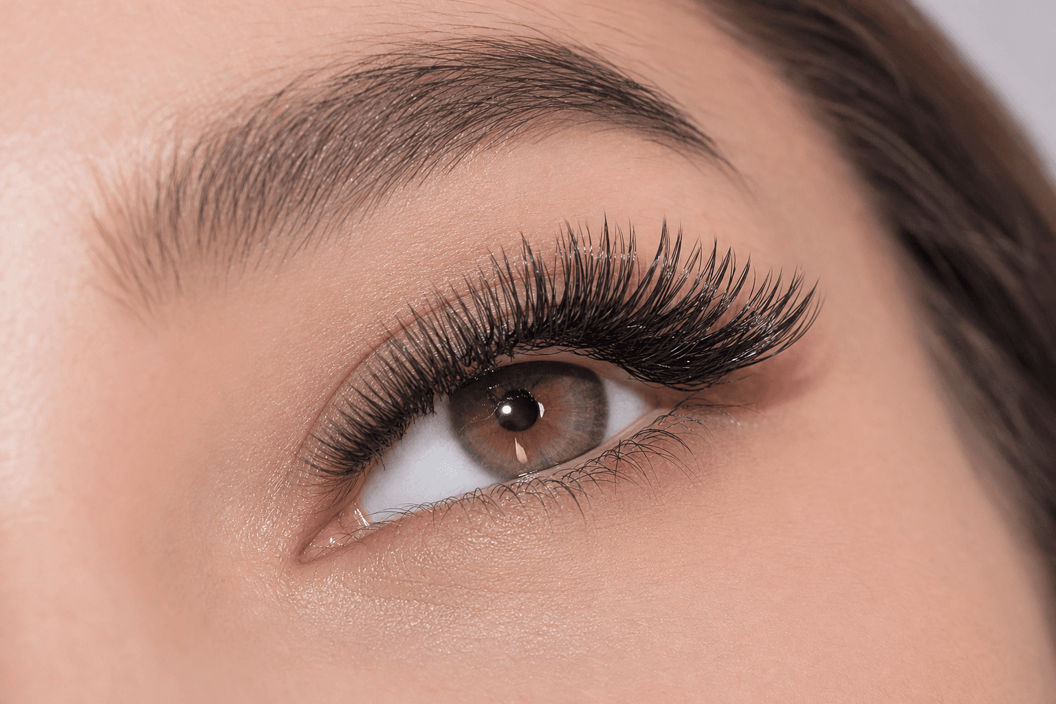 Close-up of winged, glossy foxy wet-effect lash extensions